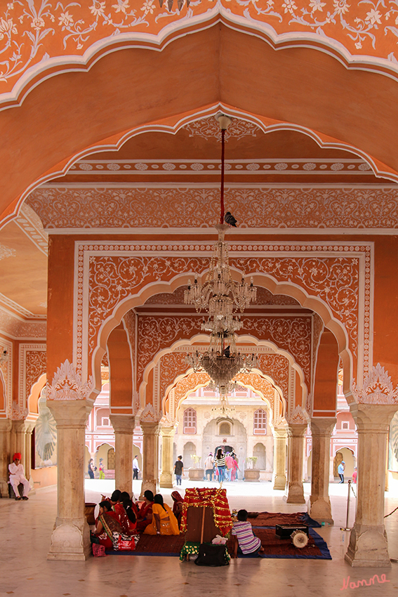 Jaipur - Stadtpalast
Zur Rechten des weiß und rosarot bemalten Hofes liegt das Diwan-i-Am, dessen prächtige Kronleuchter auf seine ursprüngliche Verwendung als Festsaal hinweisen.
Alle Türen und Tore sind mit reichen Ornamenten verziert, alle Kronleuchter unversehrt, und vor allen Sälen sind Wächter mit Turbanen und in voller königlicher Livree. 
Schlüsselwörter: Indien, Jaipur, Stadtpalast