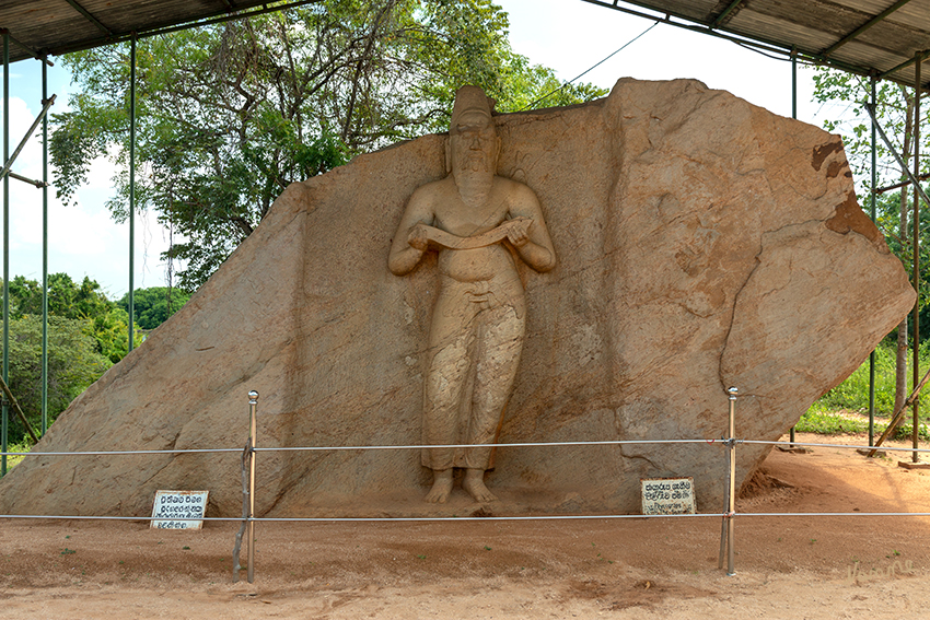 Polonnaruwa - Pothgul Vihara
Die reliefartige, aus dem Felsen geschlagene Figur zeigt einen bärtigen Mann mit freiem Oberkörper und zufriedenem Gesichtsausdruck. Es gibt keine Klarheit darüber ob es sich dabei um die Statue des großen Königs Parakrama Bahu handelt.
Seit 1982 gehört der archäologische Park von Polonnaruwa zum UNESCO-Weltkulturerbe.
Schlüsselwörter: Sri Lanka, Polonnurawa, Pothgul Vihara