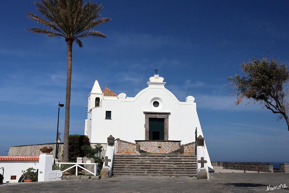 Seefahrerkirche in Forio
Bedingt durch seine lange Geschichte und die Umbauten vereinigt das Kirchengebäude nun verschiedene Baustile, den mediterranen, den maurischen und den byzantinischen, und es sind Merkmale diverser Epochen zu erkennen: ein gotisches Türmchen schmückt das Gotteshaus, das Portal ist  im Renaissancestil errichtet. Und vor der Kirche steht ein barockes Steinkreuz auf einem mit Majolikafliesen bedeckten Fundament! Auch die Umfassungsmauern des Vorplatzes sind mit Majolikamosaiken geschmückt. lt italien-reiseinformationen
Schlüsselwörter: Italien